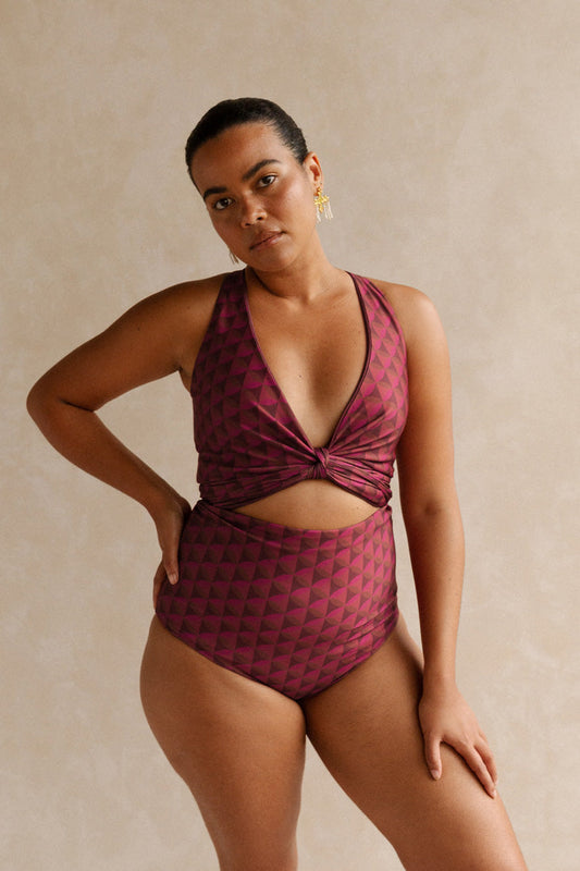 Woman wearing a burgundy bikini set with a geometric jewelled pattern.