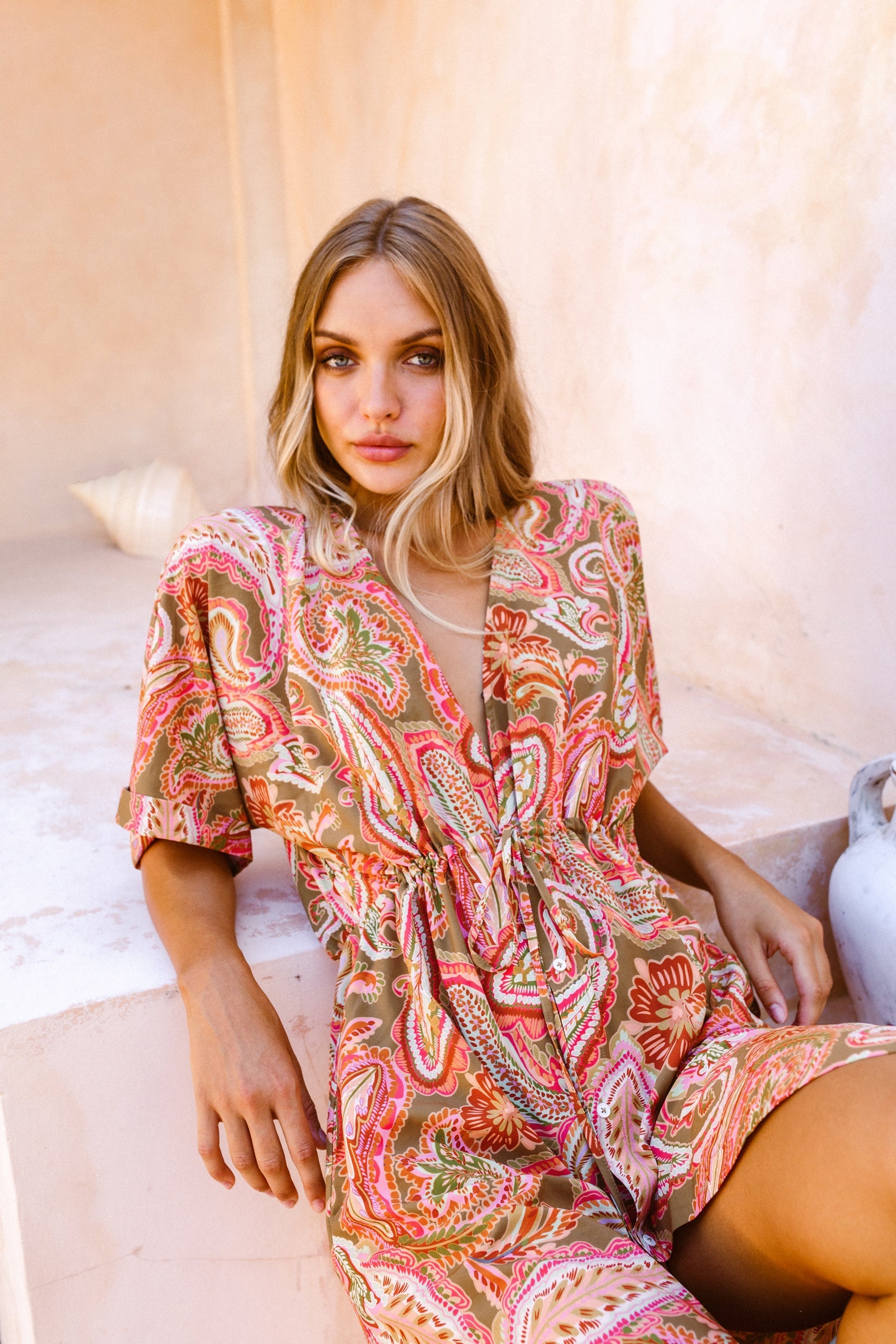 Woman laying back against stone staircase wearing the lightweight Barcelona kaftan dress 