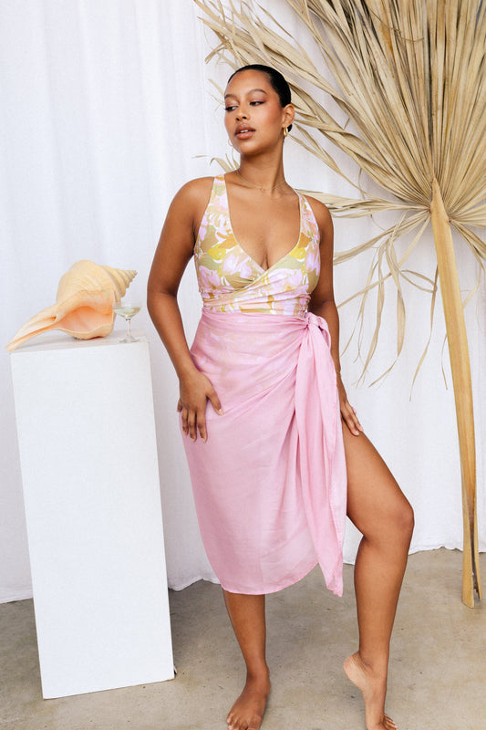 Pastel pink sarong worn as a beach cover-up