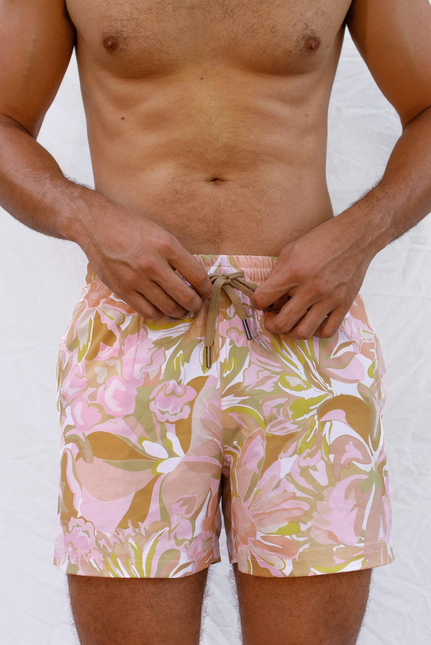 Man wearing pastel floral board shorts 