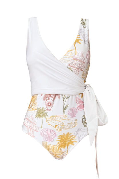 Product image of the Havana reversible wrapsuit when the white chest piece is combined with the body piece of the colourful vintage post-card motifs printed side.