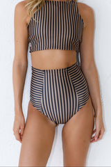 Woman wears high neck striped bikini and high waisted bottoms.